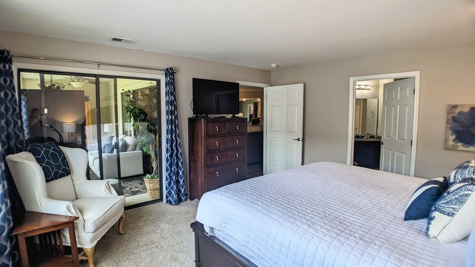 Primary bedroom with ensuite bathroom and access to sun porch
