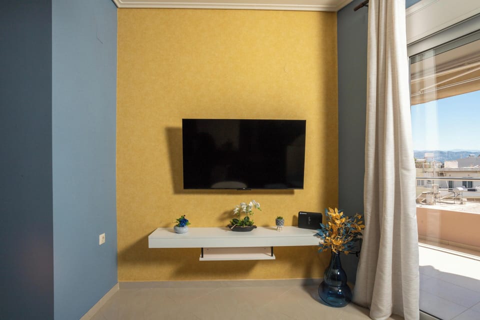 Apartment, City View | Living area | 50-inch Smart TV with cable channels