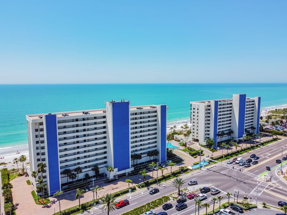 Front of the Ocean Sands buildings from an aerial view. Enjoy be - Front of the Ocean Sands buildings from an aerial view. Enjoy being steps to the sand and gentle Gulf waters!