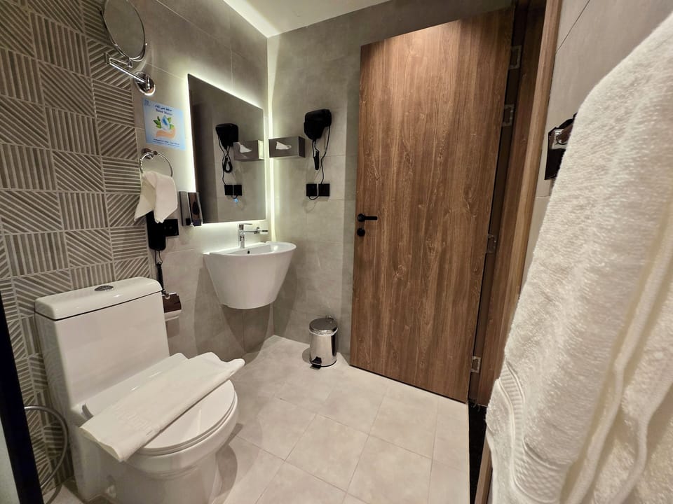 Shower, hair dryer, slippers, towels