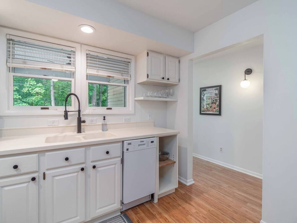Downstairs kitchen looking out on front porch and wooded space