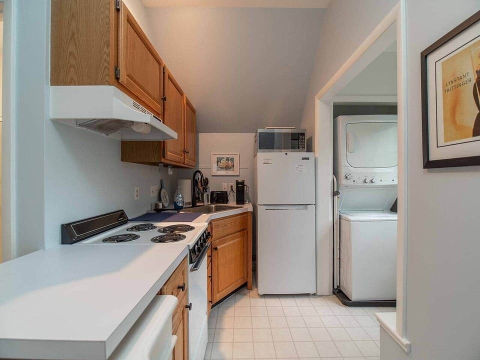 Upstairs efficiency kitchen with range, microwave, convection oven and fridge
