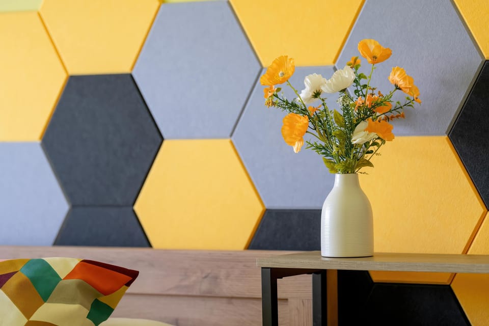 Another perspective of the decorative geometric wall paneling, blending shades of yellow, gray, and blue.