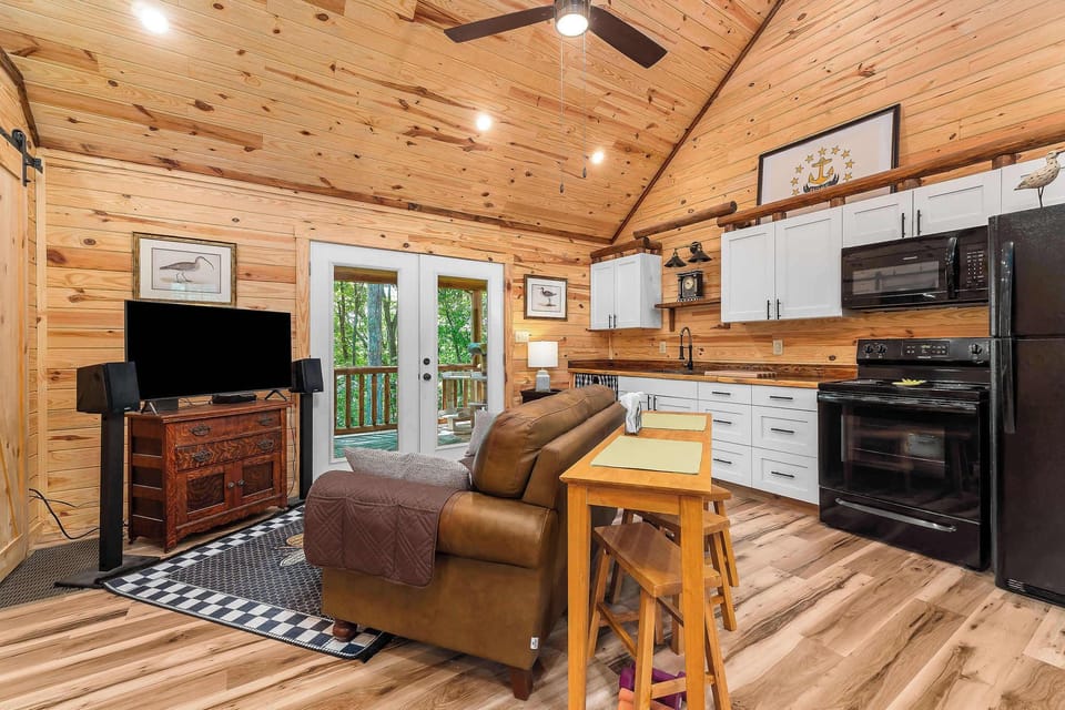 Every inch is well-utilized—from the cozy bench seating to the ladder-access loft above—designed with both comfort and flexibility in mind.