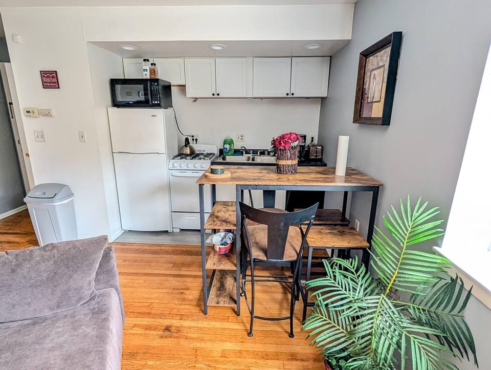 Kitchen with table including 4 bar stools.