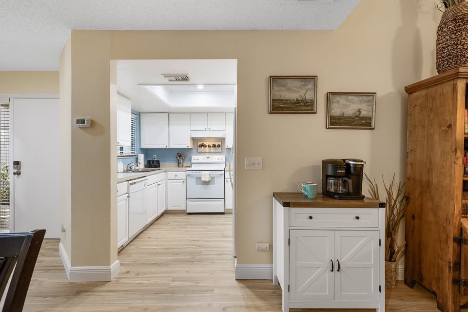 Start your beach day right in this bright coastal kitchen with a convenient coffee nook. Enjoy your morning brew before heading out for sun, sand, and seaside adventures.