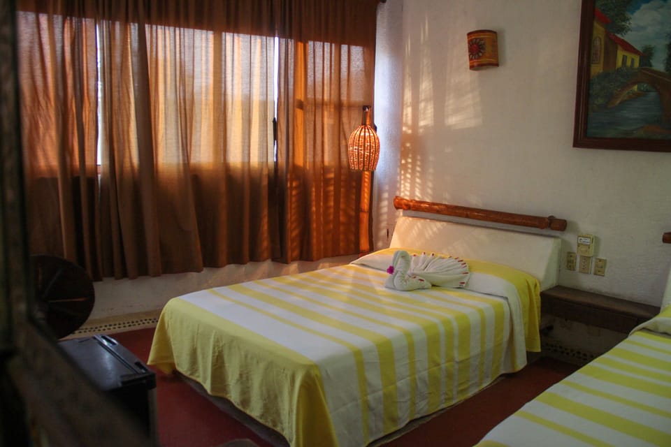Family Room, 2 Double Beds | In-room safe, blackout drapes, free wired internet