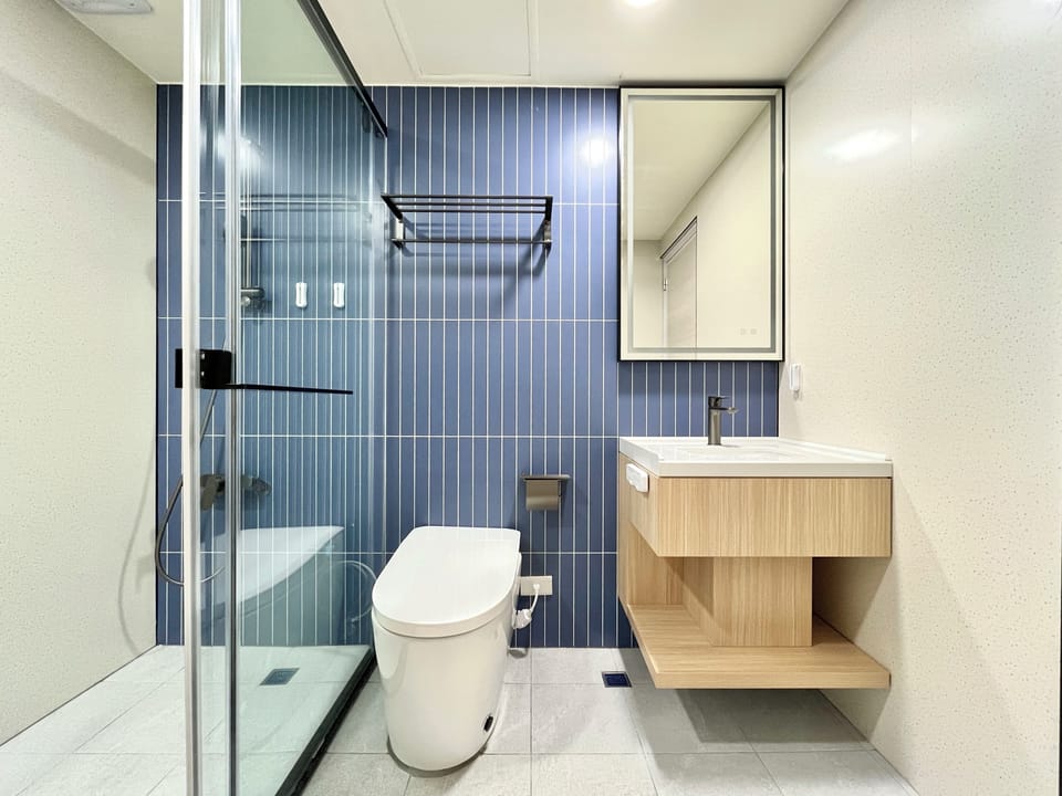 Shower, hair dryer, slippers, towels