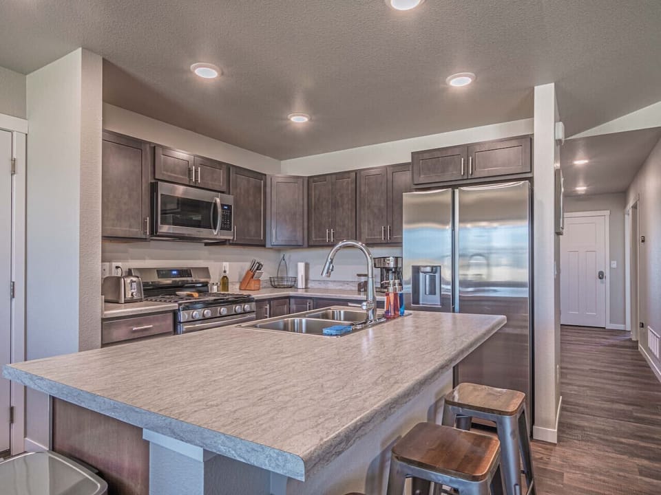 Kitchen equipped with a double-door fridge, oven, microwave, stove, and plenty more to make you feel right at home.