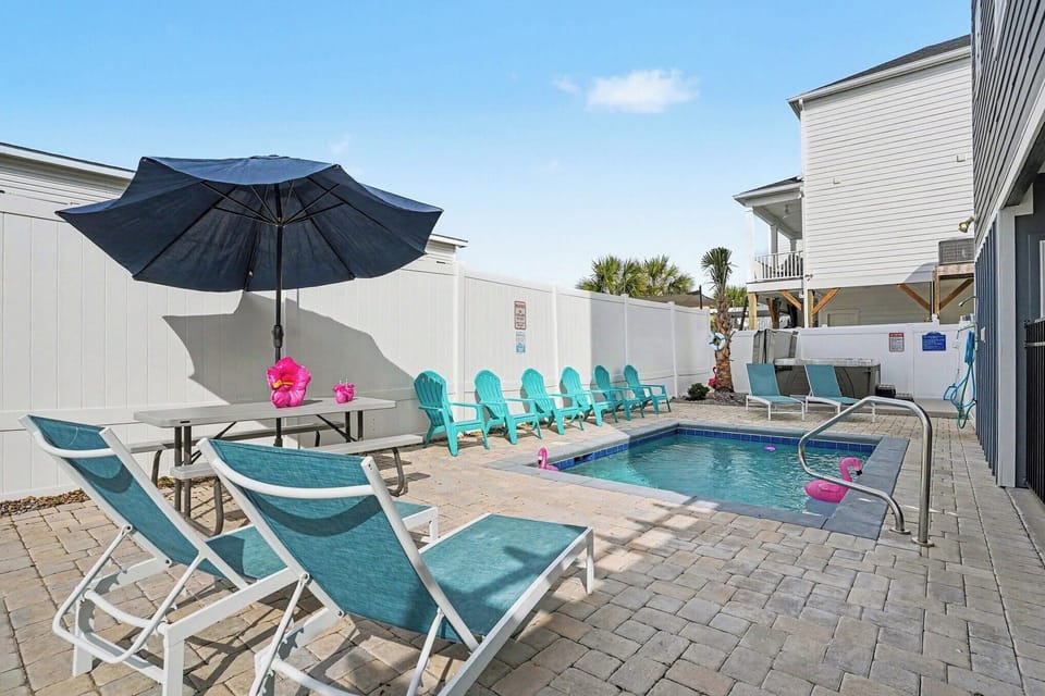 Full backyard setup — pool, hot tub & plenty of seating.