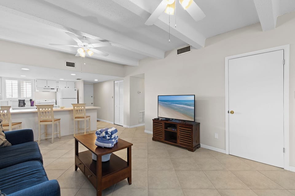 Unwind after a day on the beach in this cozy living space with coastal décor, comfy seating, and a TV for laid-back beachfront evenings at your vacation retreat.