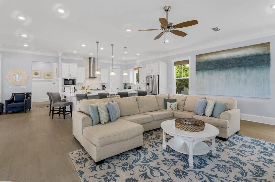 Sink into the sectional beneath a smart TV in this bright space.