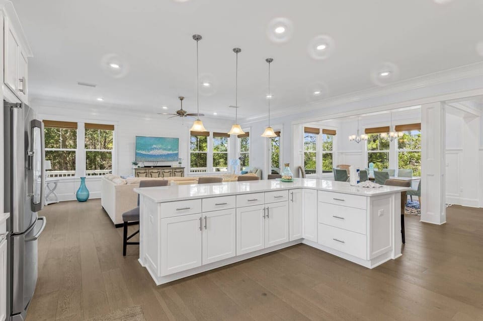 A massive island anchors the open kitchen and living area.