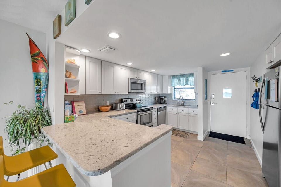 Modern kitchen w/ a generous island, perfect for prepping, chatting, and snacks.