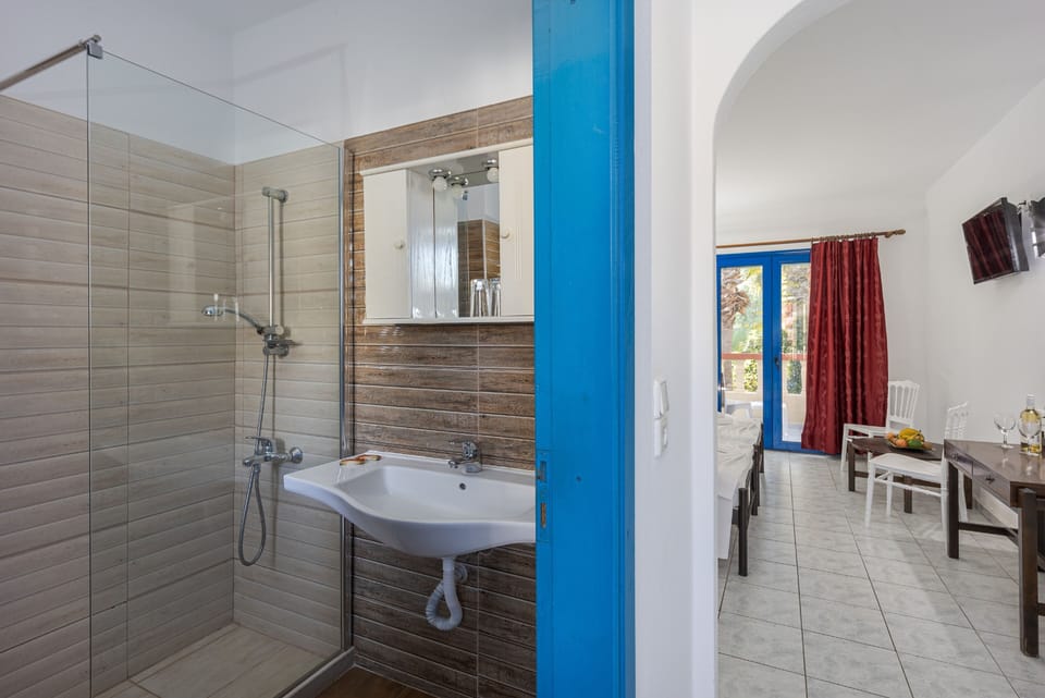 Comfort Triple Room, Bay View | Bathroom | Shower, hair dryer, slippers, towels