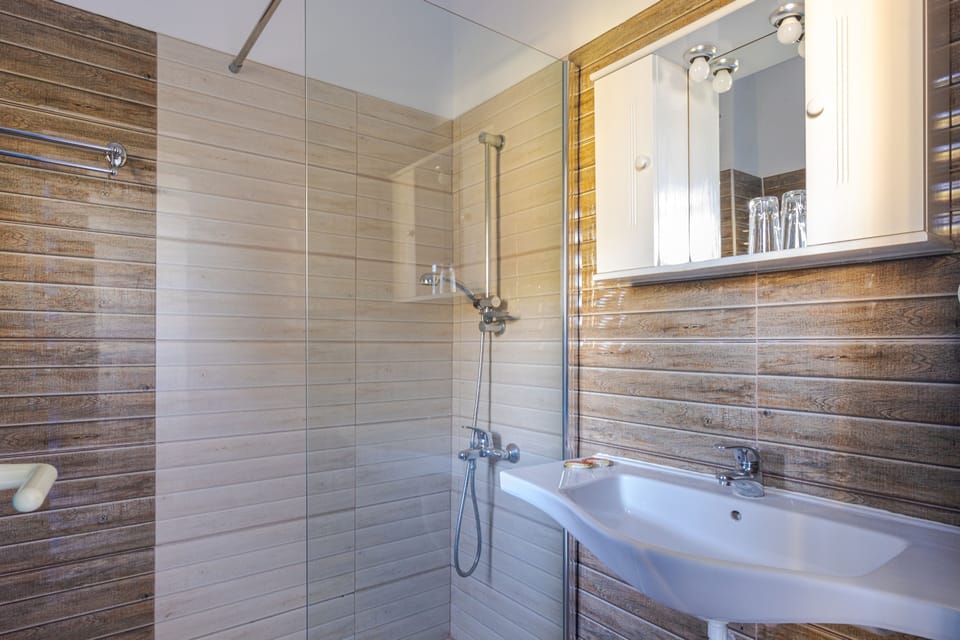 Comfort Triple Room, Bay View | Bathroom | Shower, hair dryer, slippers, towels
