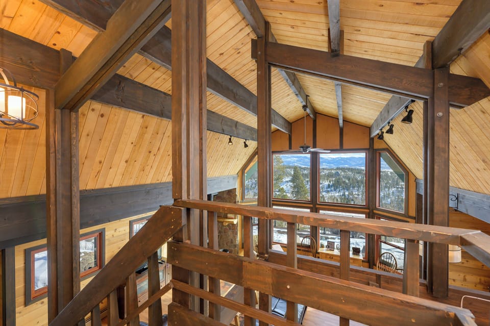 Admire stunning mountain views from the dramatic timber-framed loft space, where exposed beams create a cozy alpine atmosphere.