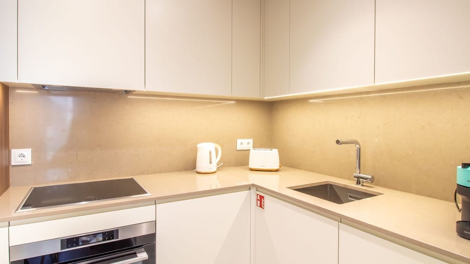 Fully equipped modern kitchenette with premium appliances and ample counter space for home cooking. #ChefFriendlyKitchen #HomeCookingAbroad #KitchenLove