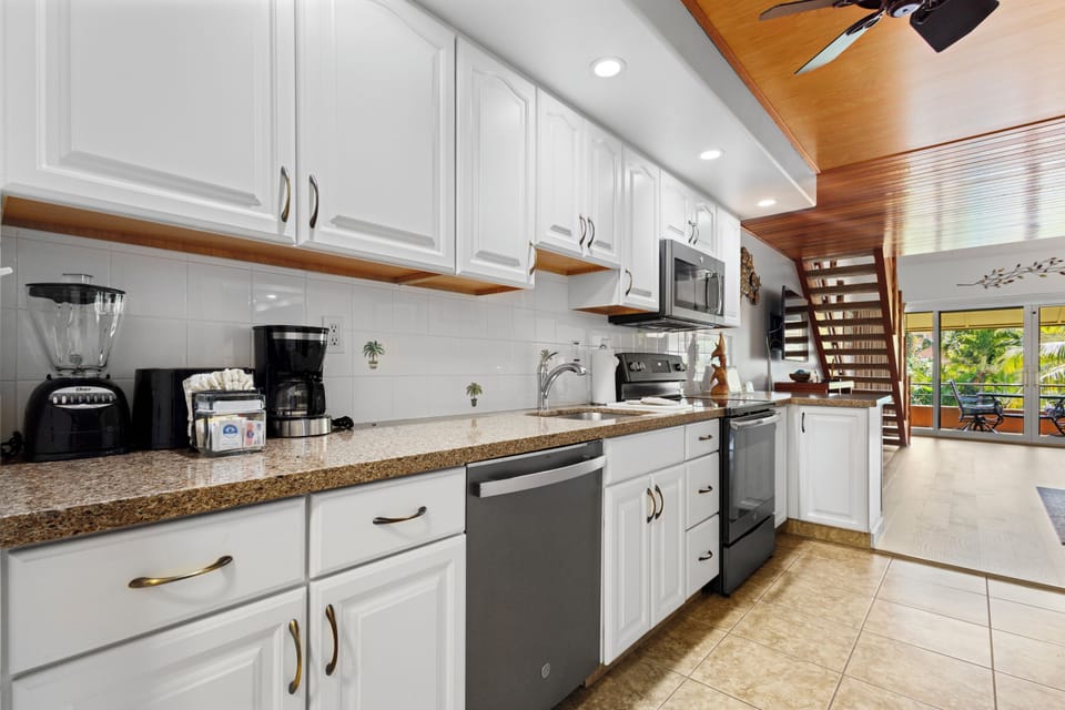 Your fully equipped kitchen features gleaming granite countertops, modern appliances, and ample storage space—perfect for preparing meals together during your stay.