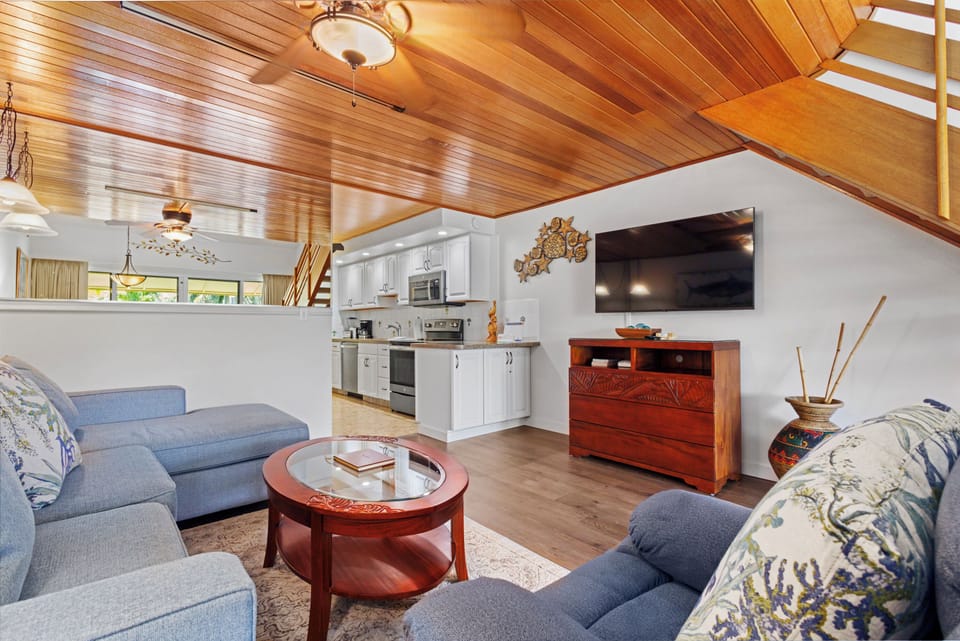 Relax in your open-concept space with soaring wood ceilings, a fully equipped kitchen, and comfortable lounge seating—your home base awaits.