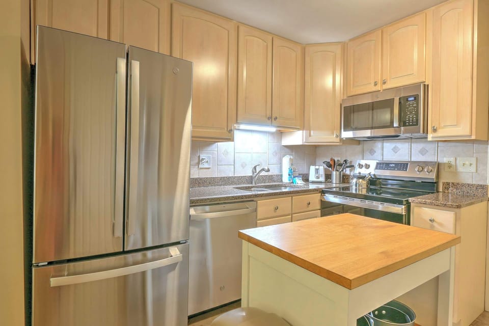 The bright, airy kitchen offers ample space & all the comforts of home