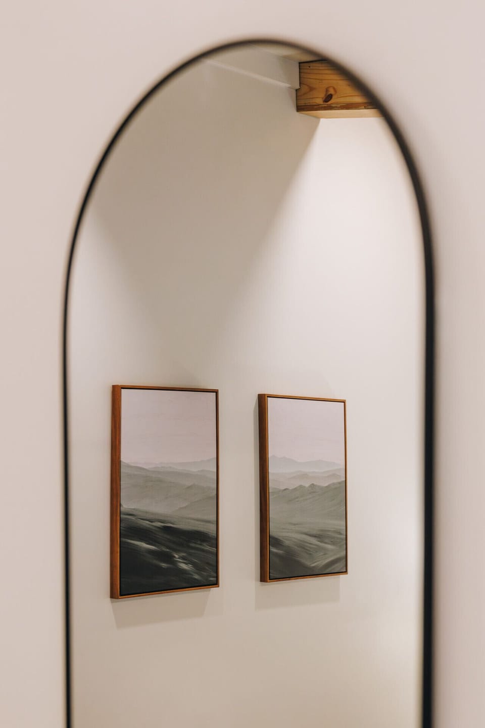 A detail of the full-length mirror captures the soft mountain artwork reflected back, adding depth and a touch of the Gorge’s natural beauty to the room.