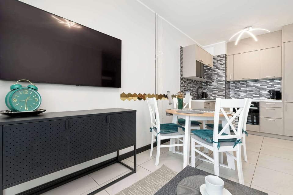 The dining area with soft velvet chairs and an elegant dark sideboard creates the perfect setting for shared meals.