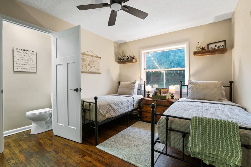 1/2 Bathroom Located in Bedroom #3. This cozy room offers two twin beds with crisp linens, charming décor, and a sunlit window. With its convenient private bath, it’s the perfect retreat for kids, friends, or family to relax and recharge in comfort.