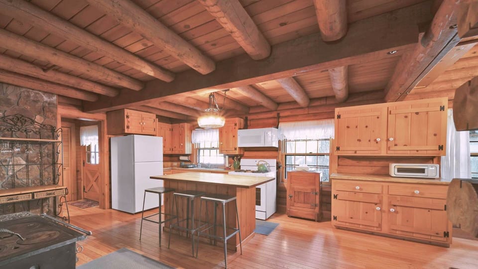 The living room opens effortlessly to the rest of the cabin, making it easy to transition between cozy indoor lounging and outdoor forest adventures. A true retreat in the woods, this space sets the tone for a peaceful and memorable mountain stay.