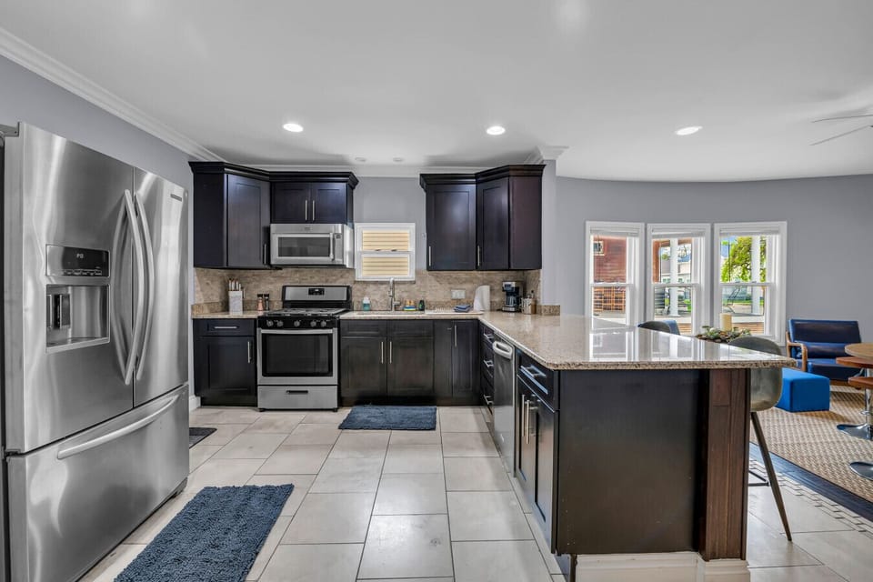 This kitchen has “Pinterest board come to life” energy. Granite, stainless, and way too much room to pretend you’re on Top Chef.