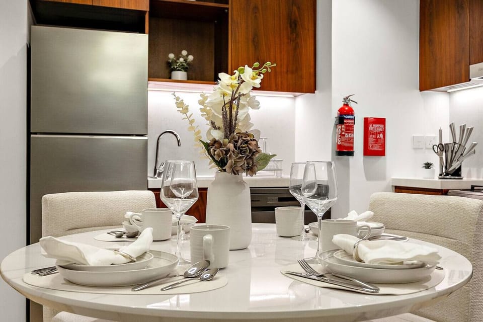 Dining Area: Elegant round table set for unforgettable meals in your Dubai getaway!