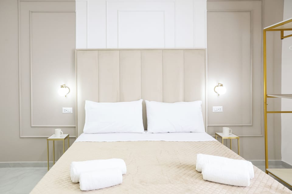 Room with beige bed | Blackout drapes, soundproofing, free WiFi