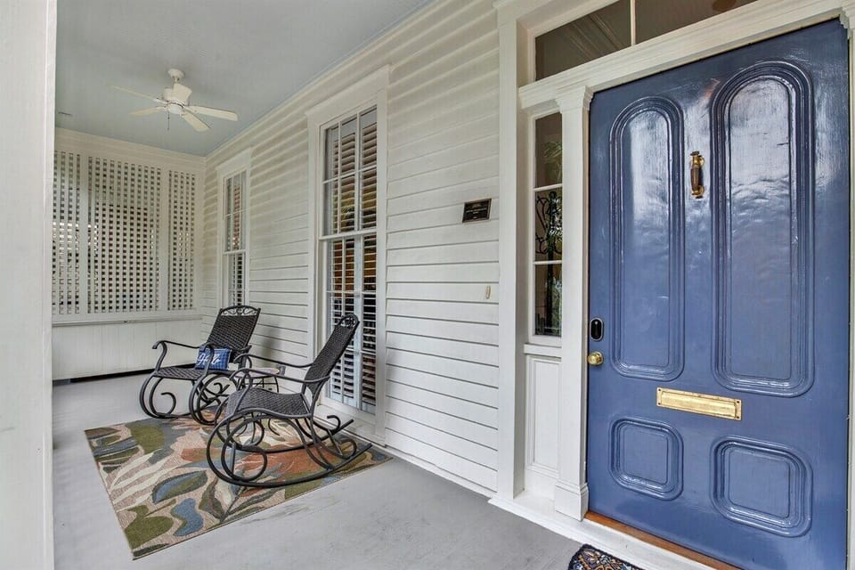 Cozy front patio with two chairs—perfect for morning coffee or evening chats.