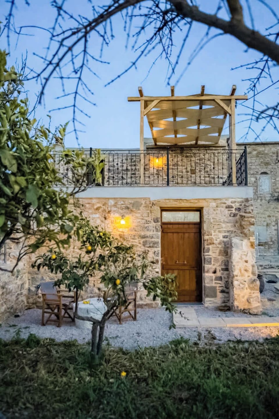 Traditional Stone House Exterior with Warm Evening Lighting