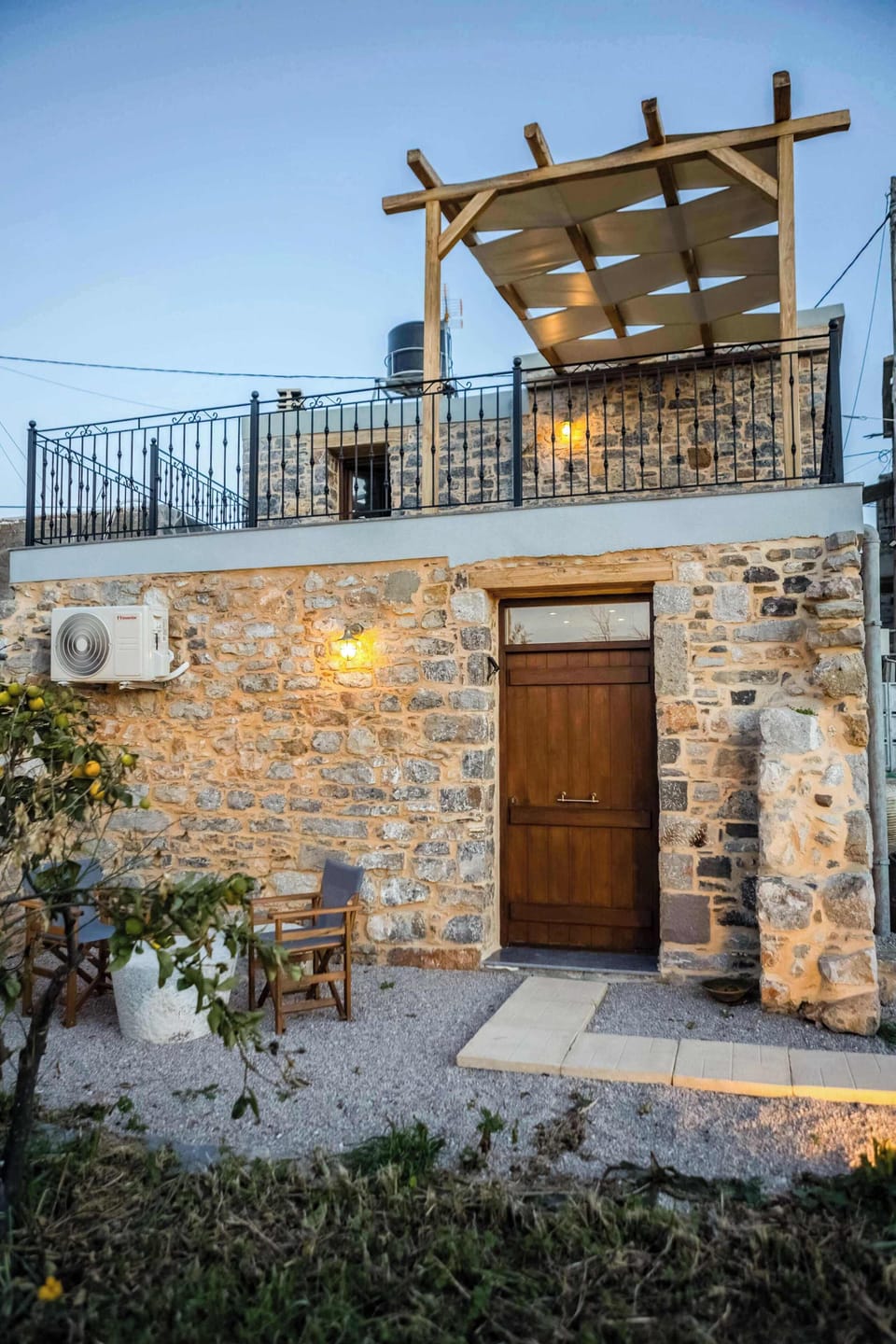 Stone House Exterior View with Courtyard – Daytime