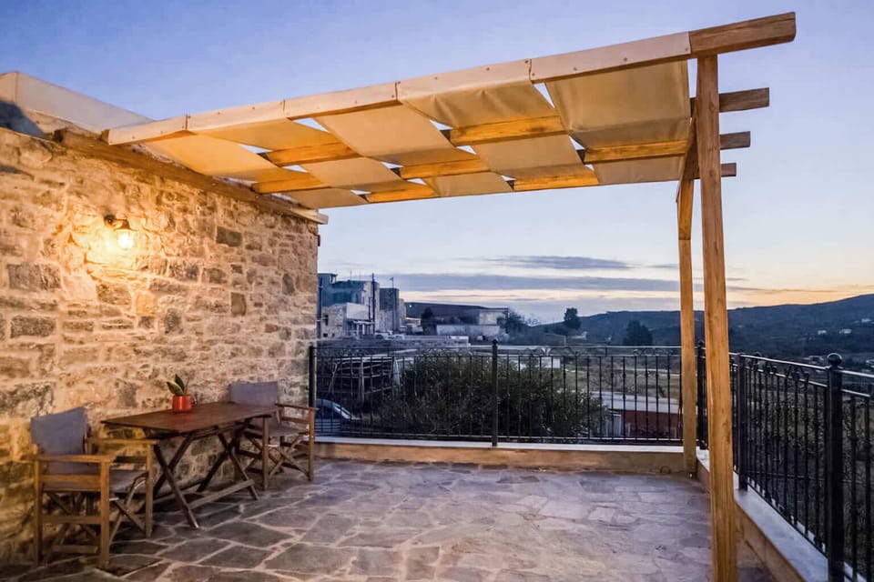 Covered Outdoor Seating Area with Stone Walls and Countryside Views