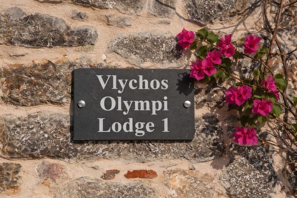 Exterior Stone Wall Detail with Property Sign and Flowers
