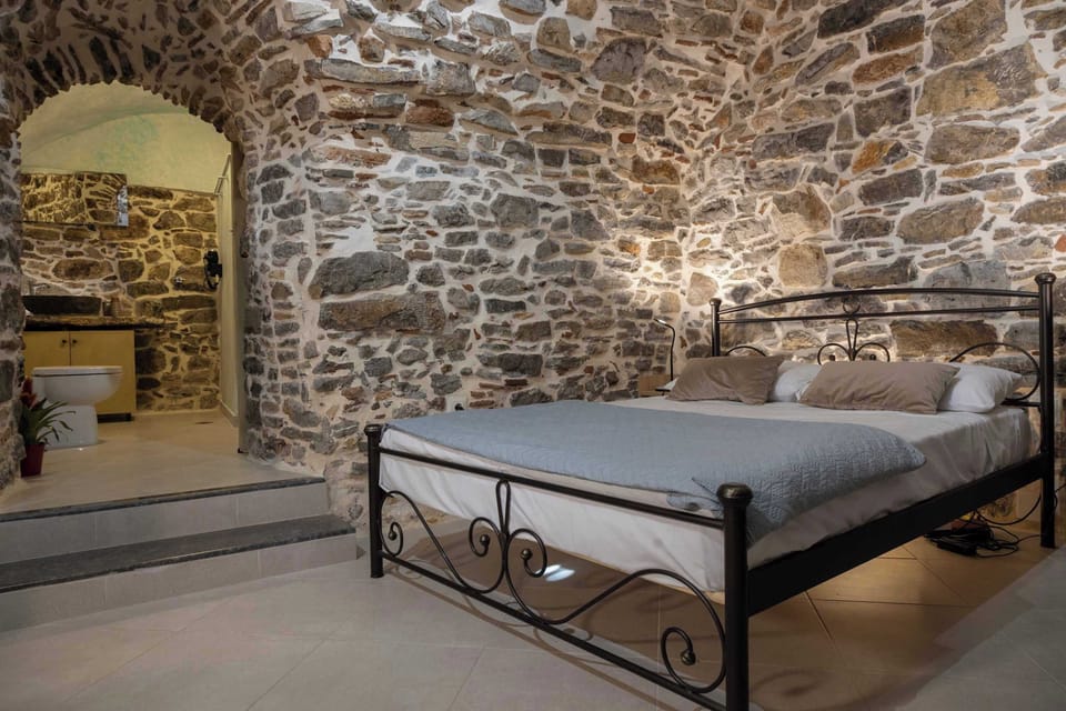 Double Bedroom with Stone Walls and Comfortable Bed