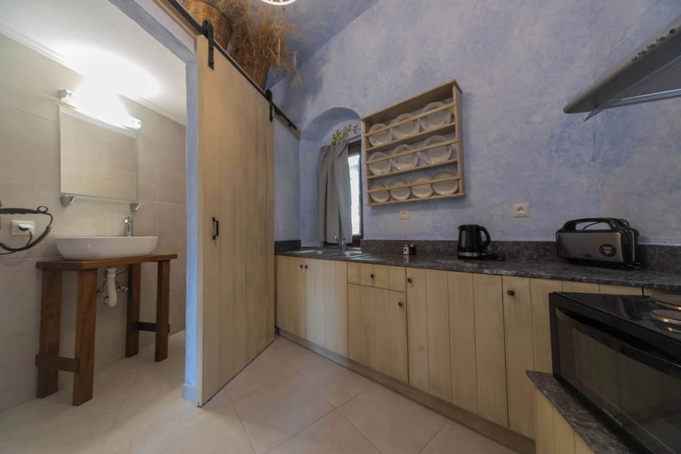 Kitchenette with Wooden Cabinets and Essential Appliances for Home Cooking