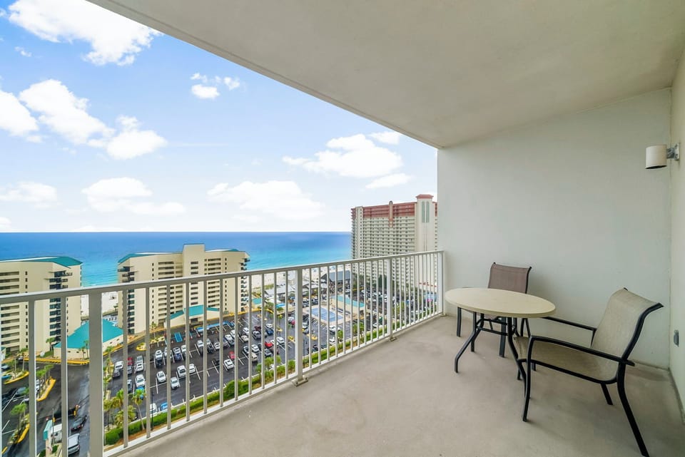 Relax on the balcony with ocean views and seating for two.