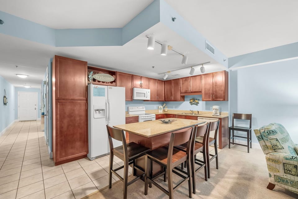 spacious kitchen with wooden cabinetry and a central island for dining