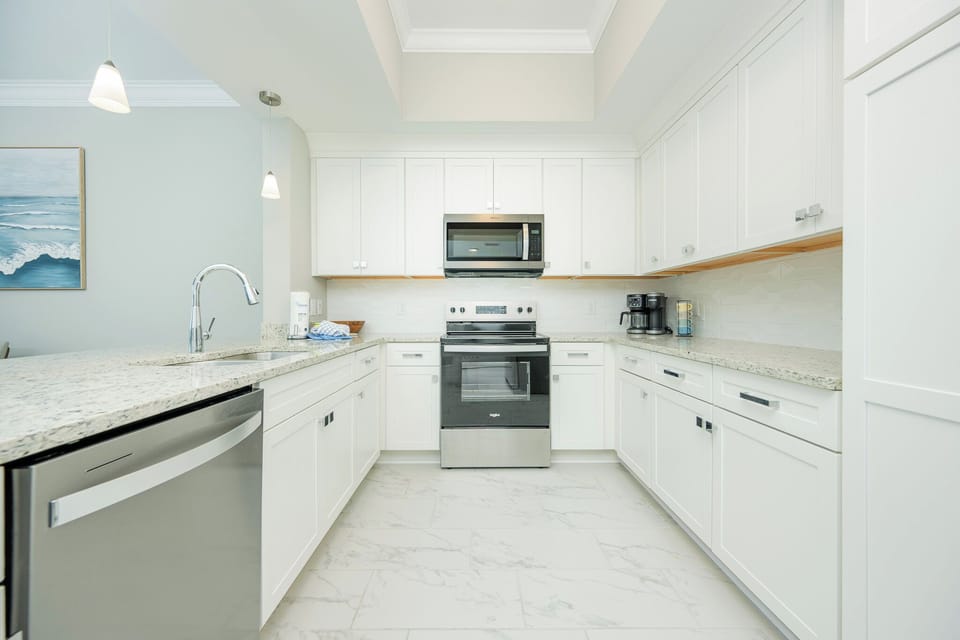 Prepare meals in this stylish kitchen featuring sleek granite countertops and stainless appliances