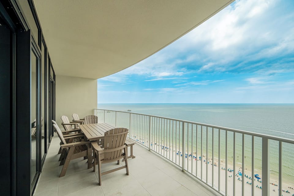 Relax on your balcony while enjoying the expansive views of the tranquil water and beach below