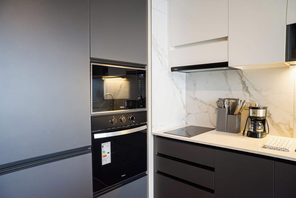 Sleek and modern kitchen with high-end appliances, perfect for preparing meals in style.