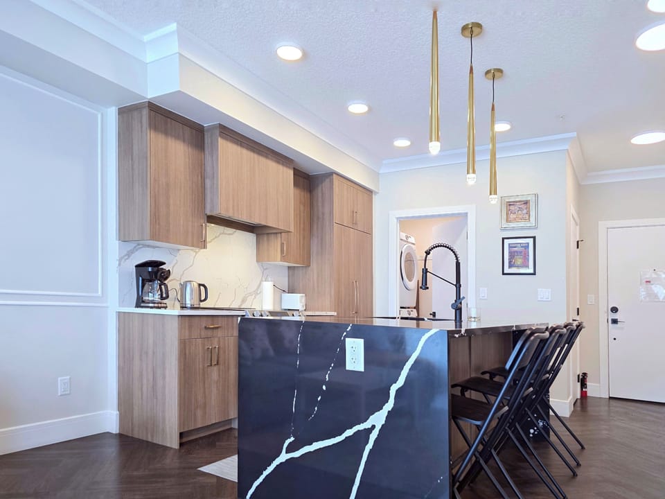 Modern Calgary condo kitchen & island, open-concept dining