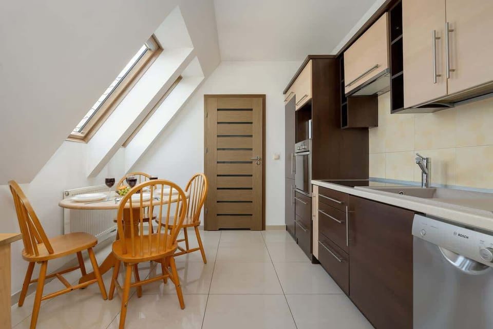 Kitchenette with elegant dining area, functional layout, and decorative food accents.