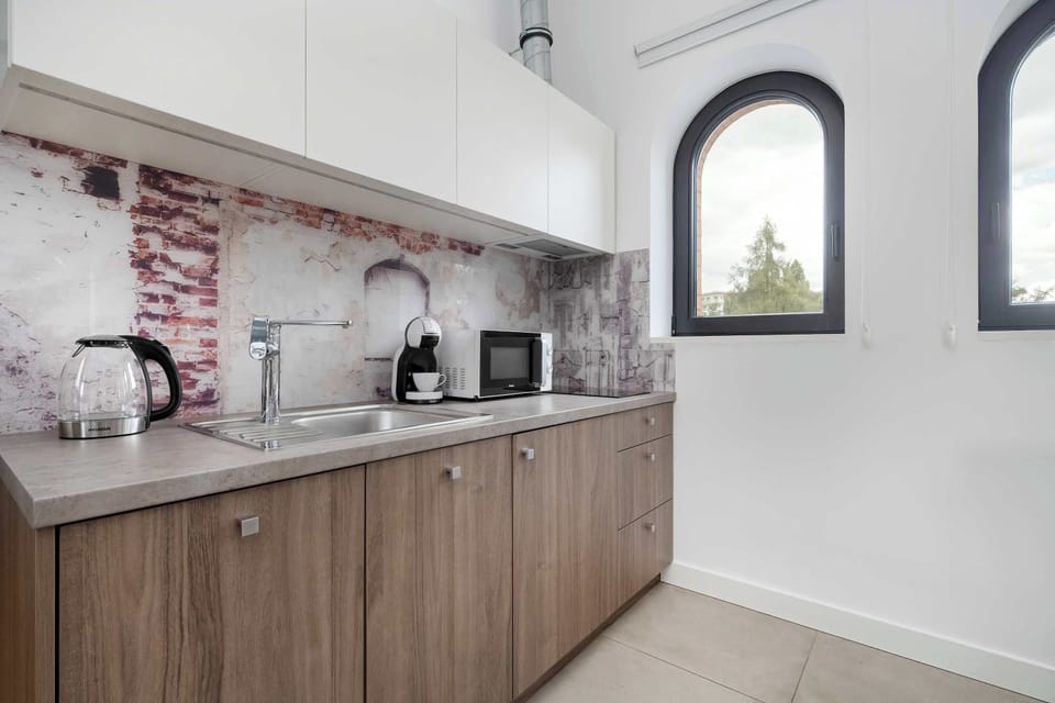 The sleek design of the kitchenette blending seamlessly with the living area.