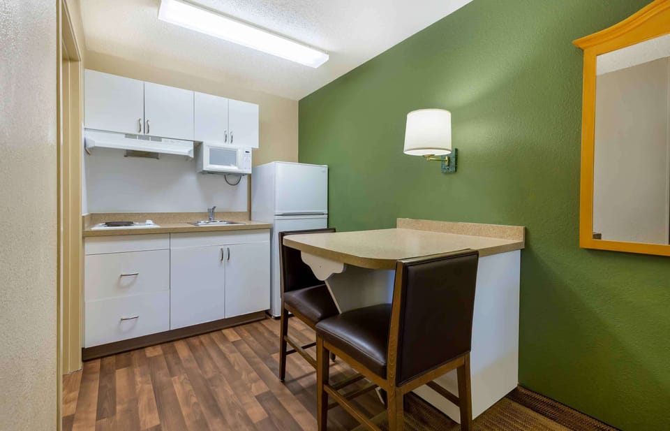 Desk, laptop workspace, blackout drapes, iron/ironing board