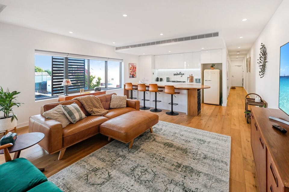 Spacious open-plan living and dining with warm natural tones