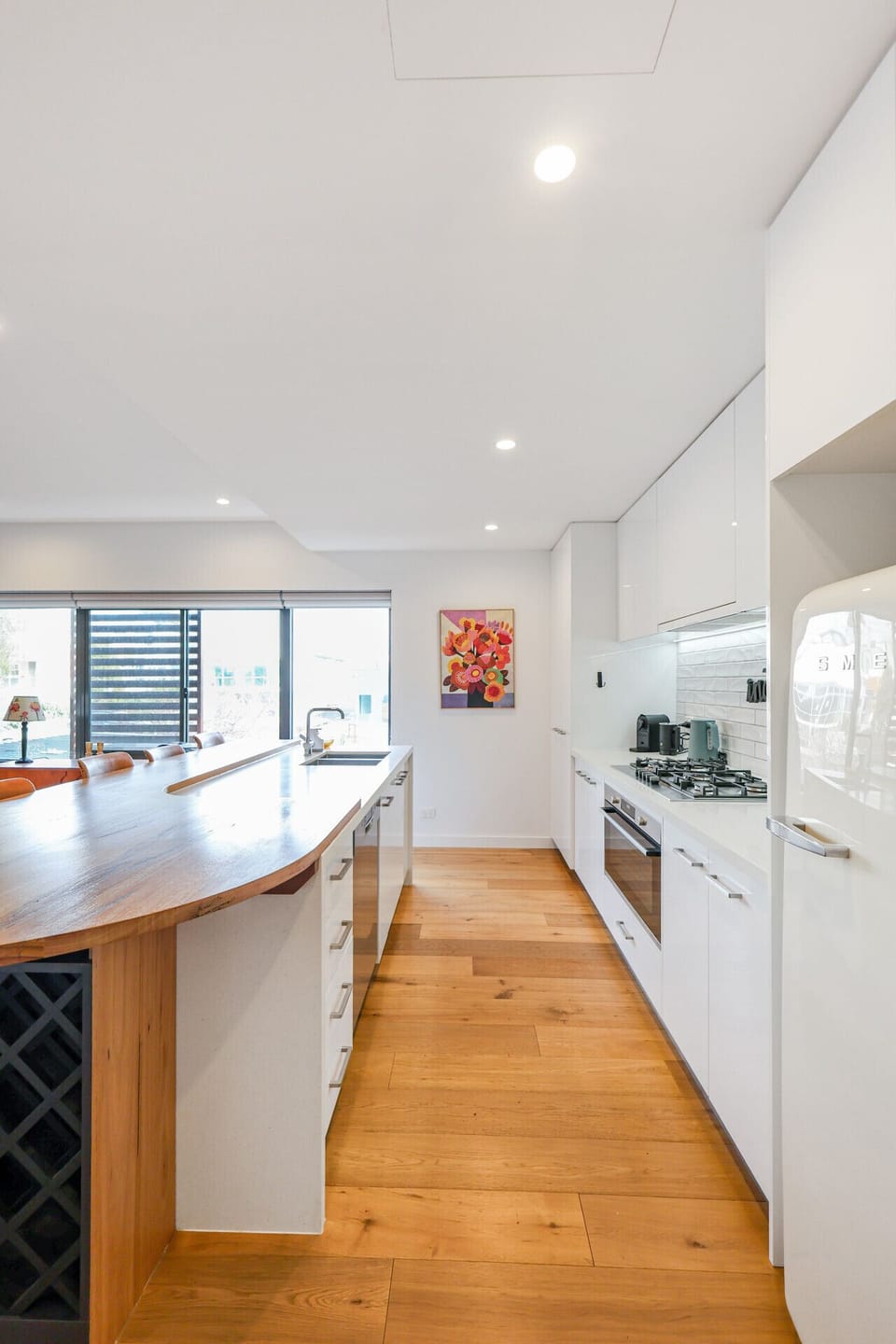 Modern kitchen with extended island and natural light from large windows